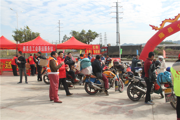 圖為藤縣總工會(huì)在省道304線藤縣陶瓷工業(yè)園區(qū)商業(yè)街小廣場(chǎng)設(shè)立藤縣總工會(huì)為農(nóng)民工平安返鄉(xiāng)“暖流行動(dòng)”服務(wù)站，積極為騎摩托車(chē)